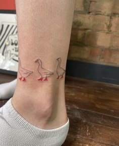 a woman's foot with three ducks on it