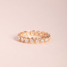 a gold ring with three rows of diamonds