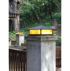 a light that is on top of a cement pillar