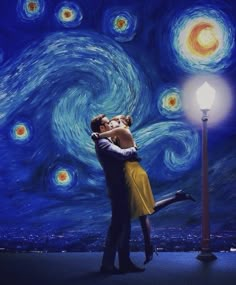 a man and woman kissing under a street light in front of an image of the night sky