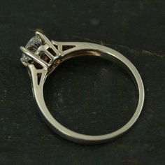 a diamond ring sitting on top of a table