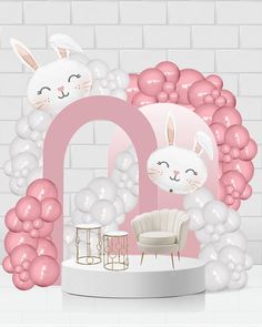 a pink and white room with balloons in the shape of bunnies, bunny ears, and a chair