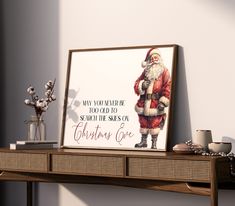 a christmas card with santa claus holding a bag on top of a shelf next to a vase