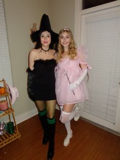 two women dressed in costumes posing for the camera