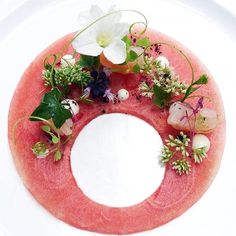 a watermelon plate with flowers and leaves on it