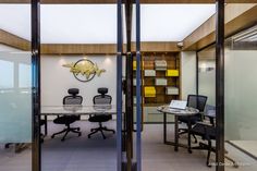 an office with glass walls and chairs