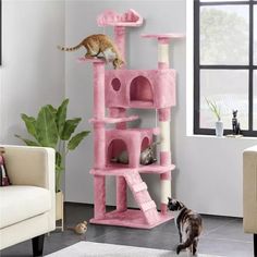 a cat climbing up the side of a pink cat tree with two cats on it