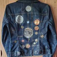 Hand-painted Astronomy Jean Jacket, Size Women's XS/S, Upcycled A one-of-a-kind denim jacket painted with a golden geometric pattern, featuring the moon and various stars (not to scale). Combination of fabric paint and acrylic paint mixed with fabric medium. Hand-washing is recommended, or turn the jacket inside out and machine wash on gentle cycle with cold water (may cause the design to fade faster), and then leave to air-dry. Model is 5'8 and wears a size XS/S. Jacket itself is Gap Limited Ed Jeans Jacket Diy Ideas, Diy Jacket Paint, Denim Jacket Painting Ideas Aesthetic, Space Aesthetic Clothes, Denim Jacket Diy Upcycling, Painted Jacket Ideas, Jacket Painting Ideas, Denim Jacket Design Ideas, Spacecore Fashion