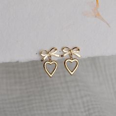 Bow Tie Heart Drop Earrings , Pretty Gold Earrings for Women, Feminine Bow Hollow Heart Earrings, Stylish Lovely Gift for Her PRODUCT DETAILS ✦ 18K PVD Gold plated over surgical level stainless steel ✦ Lead-free and Nickel-Free, a great choice for sensitive skin ✦ Hypoallergenic ✦ Tarnish-Free  ✦ WATERPROOF and SWEAT-RPOOF  Size: 11 x 22 mm Weight: 5.4 g SHIPPING & PACKAGING Our jewelries are well packaged with care and will be shipped out within 1-3 business days via USPS.  Please don't hesitat Gold Earrings For Women, Hollow Heart, Heart Dangle Earrings, Heart Drop Earrings, Pretty Jewellery, Heart Earrings, Earrings For Women, Lovely Gift, Bow Tie