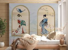 a bedroom with two paintings on the wall