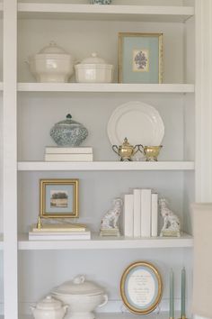 a white shelf filled with books and other items