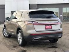 a silver suv parked in front of a building