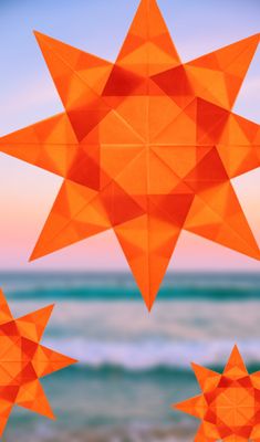 an orange star hanging from the side of a beach