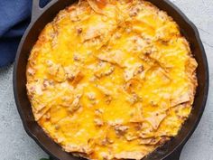 an omelet with meat and cheese in a skillet on a counter top