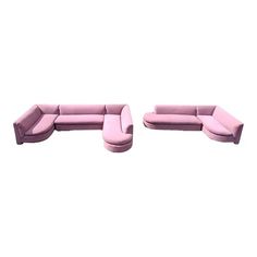 two pink couches sitting next to each other on top of a white flooring