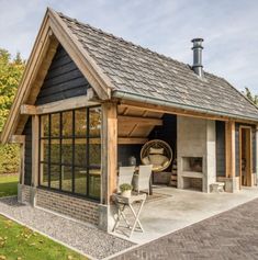 a small house with a covered patio and sitting area