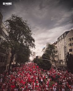 a large group of people in red and white outfits