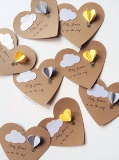 there are many hearts that have been made out of brown paper with yellow and white flowers on them