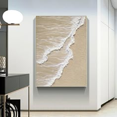 a white and beige painting on the wall in a room