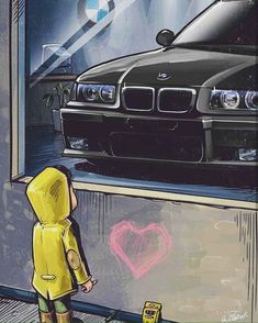 a person standing in front of a car with a heart drawn on the wall next to it