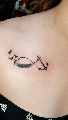 a woman with a tattoo on her shoulder has an arrow and birds flying in the sky