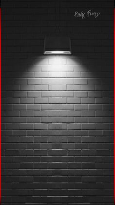 a brick wall with a red border around it and a light on the side that reads pink floyd