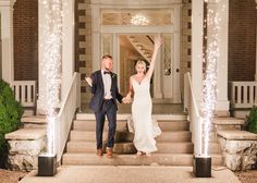 a bride and groom walking down the steps at their wedding