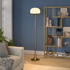 a living room with blue walls and a gold floor lamp in the corner next to a couch