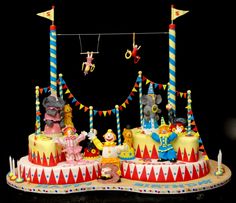 an elaborate carnival cake with clowns and circus animals