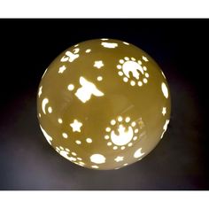 a light that is on top of a black surface with white dots and stars all over it