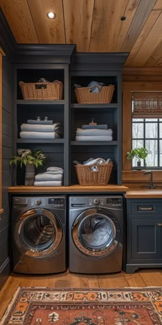 a washer and dryer in a room with wooden floors, built - in shelving