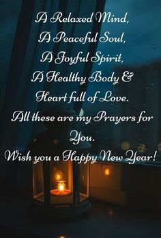 a candle lit in front of a window with the words happy new year written on it