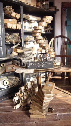 there are many pieces of wood stacked on top of each other in front of a bookcase