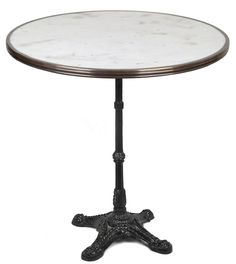 a white marble top table with an iron base and starfish design on the bottom