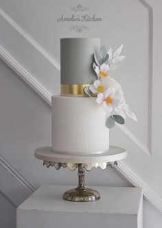 a white and grey wedding cake with flowers on top is featured in instagram's instagram