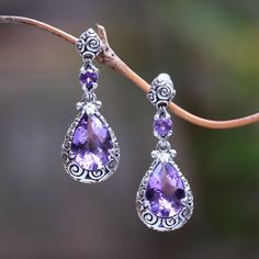 These dangle earrings feature over five carats of purple amethyst stones framed by handcrafted sterling silver spiral motifs. Inspired by the love he shares with his wife Indonesian artisan Zayd Makarim crafts the beautiful pair with the utmost care. The spiral motifs refer to Buddha's tightly-curled hair. Fantasy Jewelry Magic, Purple Stuff, Expensive Jewelry Luxury, Princess Jewelry, Amethyst Stones, The Spiral, Jewelry Accessories Ideas, Expensive Jewelry, Silver Jewelry Fashion