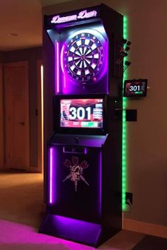 a dart board with neon lights on the sides and darts in the center, next to a television