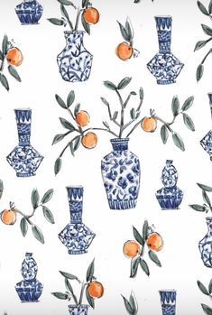 a blue and white pattern with oranges in vases on the wall next to each other