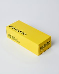 a yellow box with the sun buddies logo on it sitting on a white table top