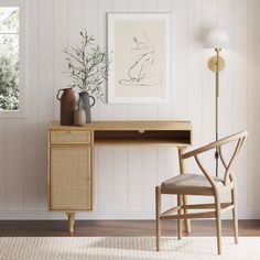 a wooden desk sitting next to a chair in a room with white walls and wood flooring