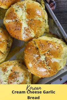 baked bread rolls with cheese and herbs in a baking pan