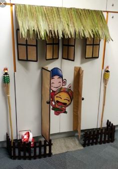 an office cubicle decorated like a house with a cartoon character on the front door