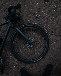 a bike laying on the ground with it's front wheel still attached to its frame