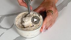 a person mixing something in a bowl with a spoon