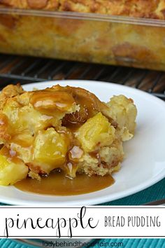 a piece of bread pudding on a plate with caramel sauce and pineapple topping