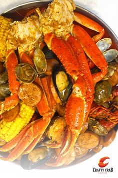 a large platter of seafood and corn on the cob