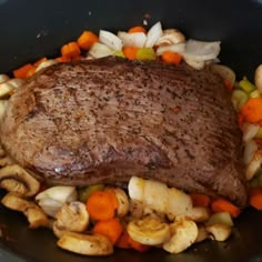 a steak and vegetables in a skillet ready to be cooked