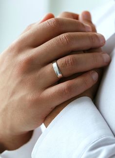 a close up of a person wearing a wedding ring