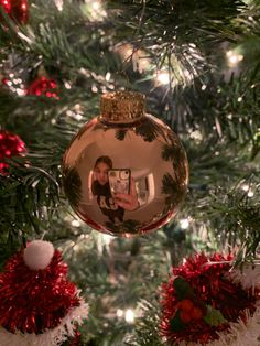 a christmas ornament hanging from the top of a tree