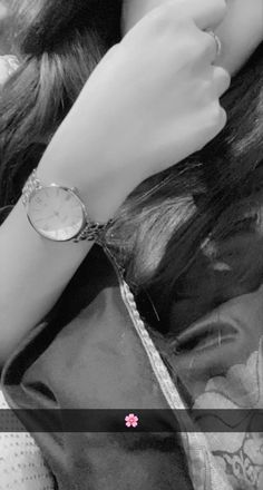 black and white photograph of a woman's arm with a watch on her wrist